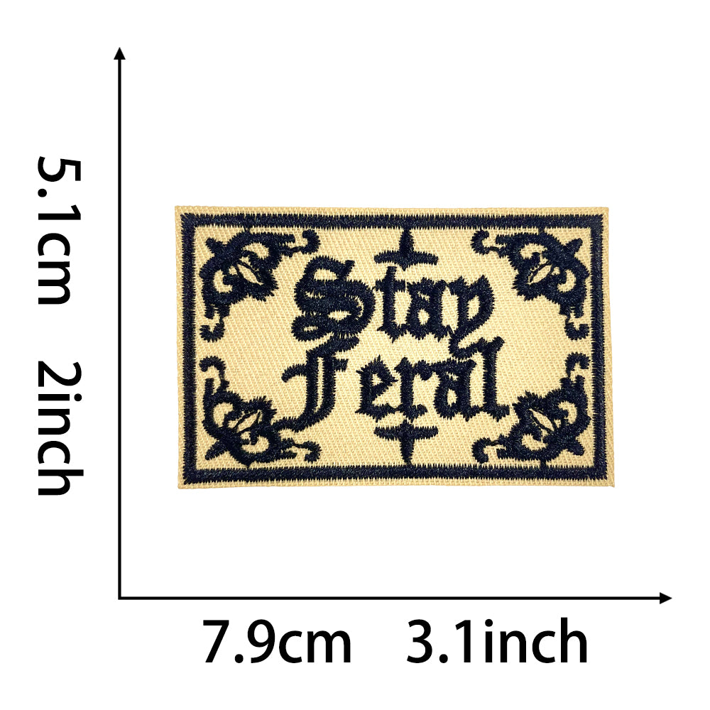Stay Feral gothic embroidered iron-on patch in black and beige, 7.9cm x 5.1cm