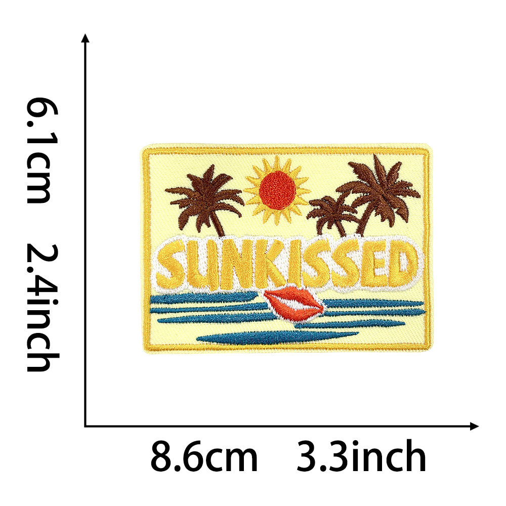 Iron on patch with "SUNKISSED" text, palm trees, sun, and lips, 8.6cm x 6.1cm