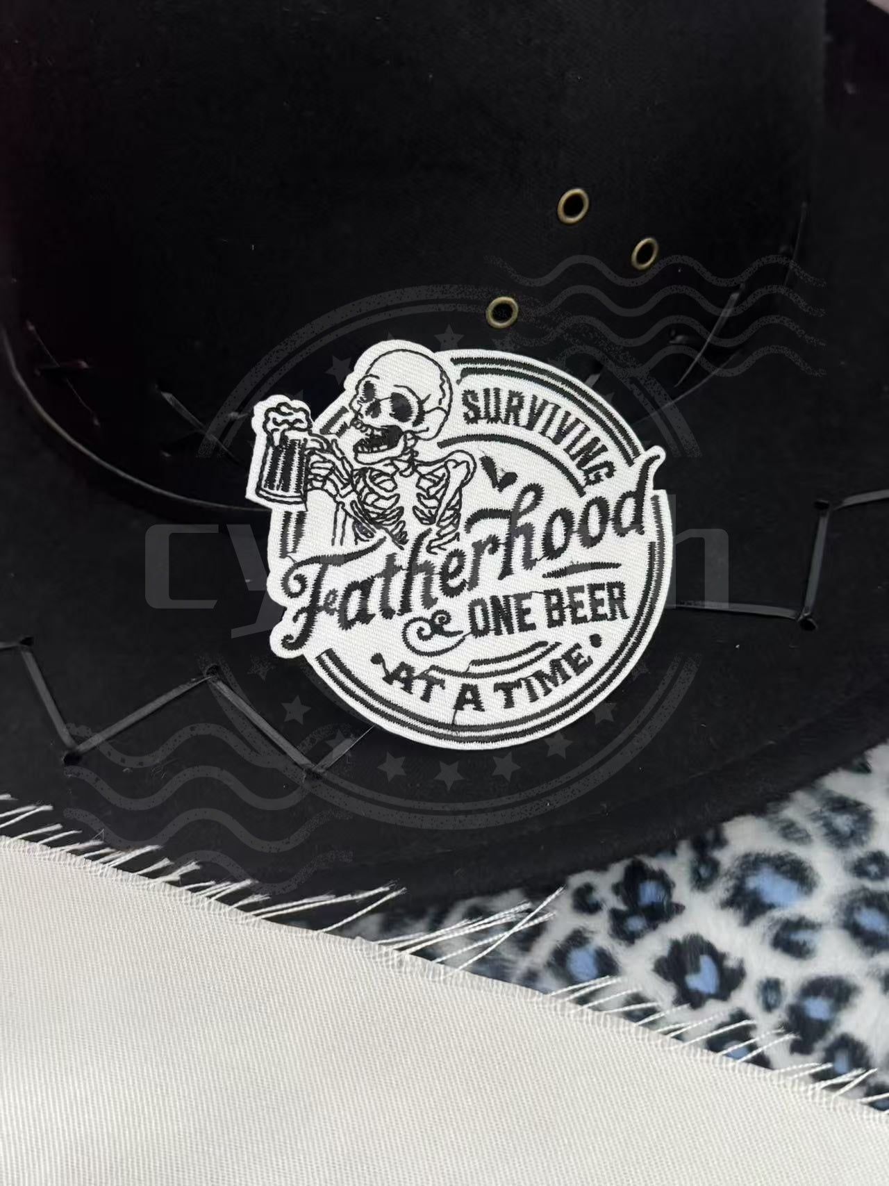 Funny embroidered patch with skeleton holding beer and the phrase “Surviving Fatherhood One Beer at a Time”