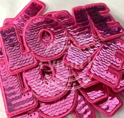 Pink sequin embroidered patch with the word LOVE in bold capital letters