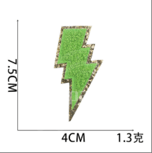 Green lightning bolt embroidered patch with gold glitter border
