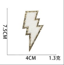 White lightning bolt embroidered patch with gold glitter edge